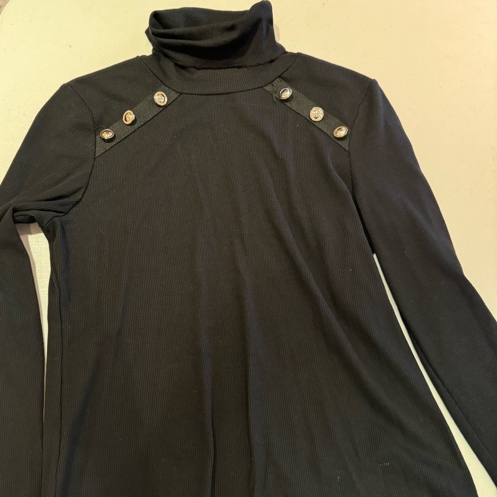 Black turtleneck with gold button detail